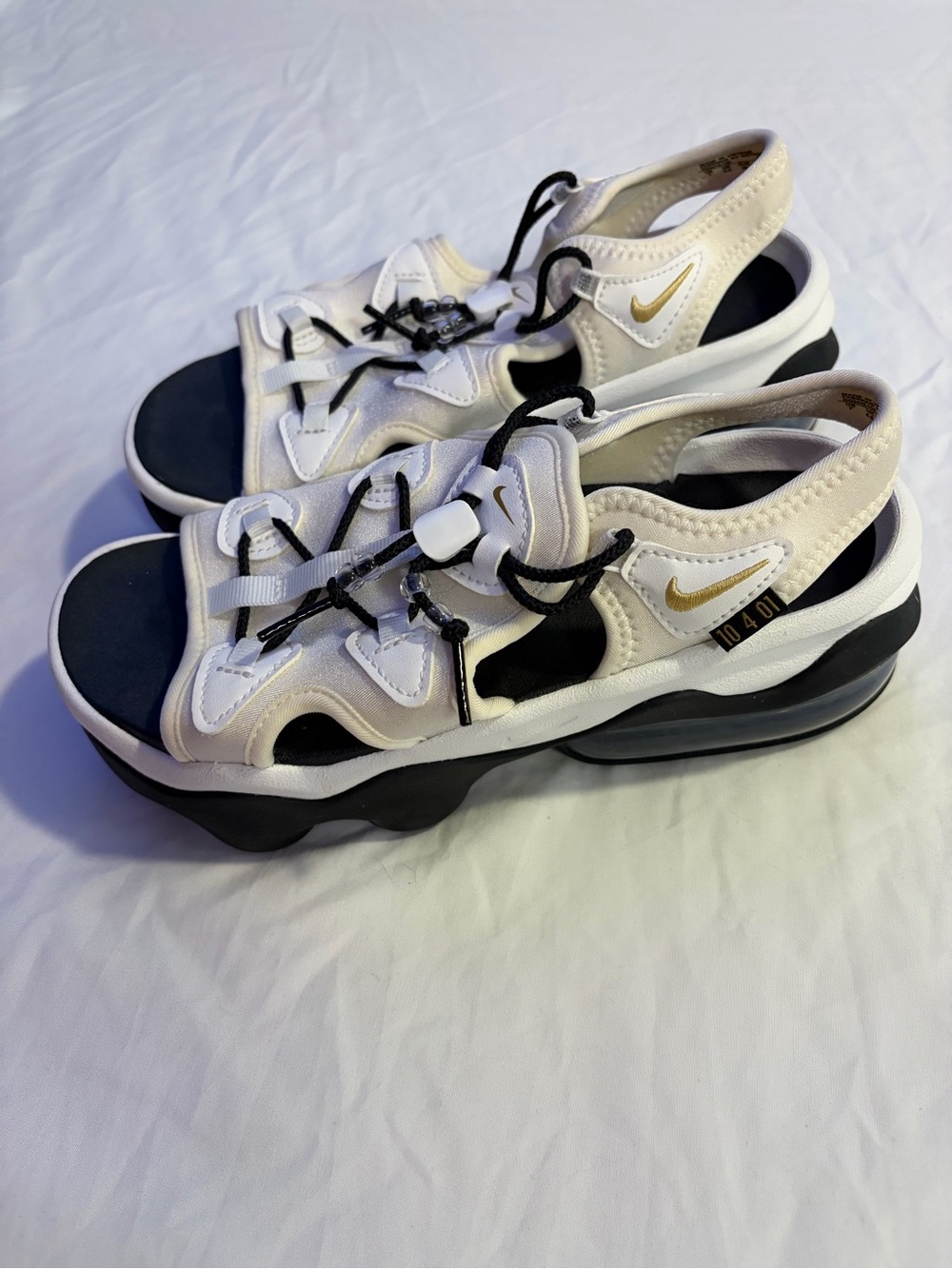 Nike Women’s White and Black Sandals with Gold Swoosh